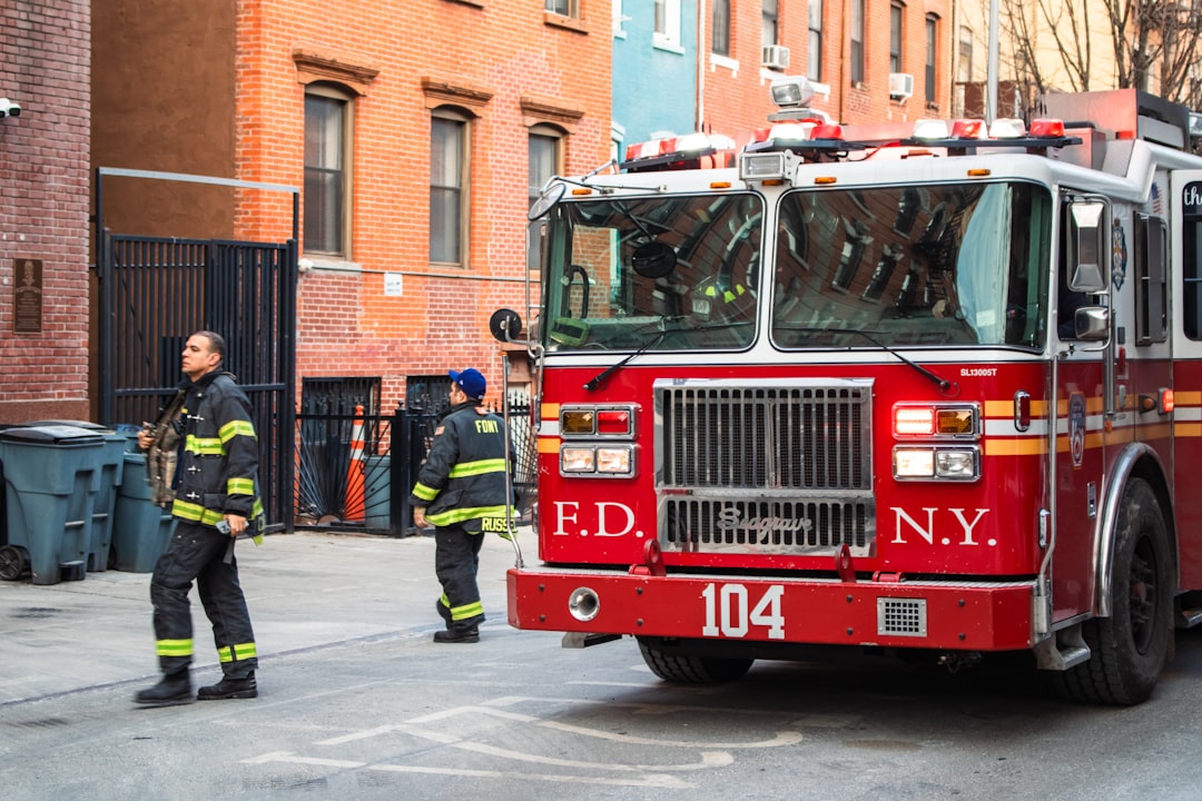 Firefighters and fire truck at a scene.