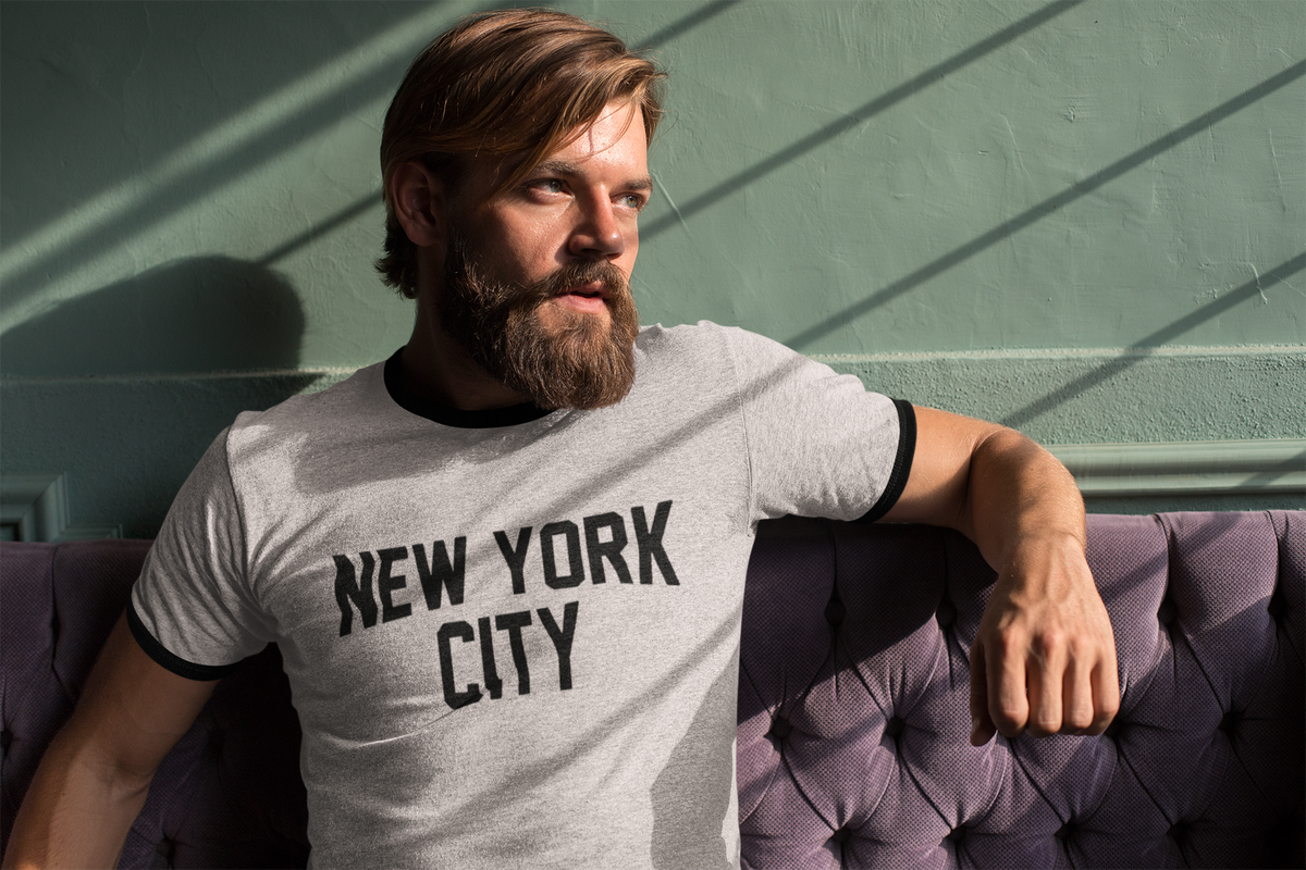 ringer-t-shirt-mockup-featuring-a-cool-bearded-man-sitting-on-a-purple-couch-27931